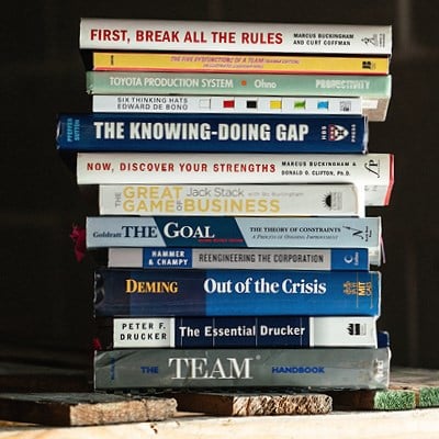 Stack of leadership books representing leadership education and professional development